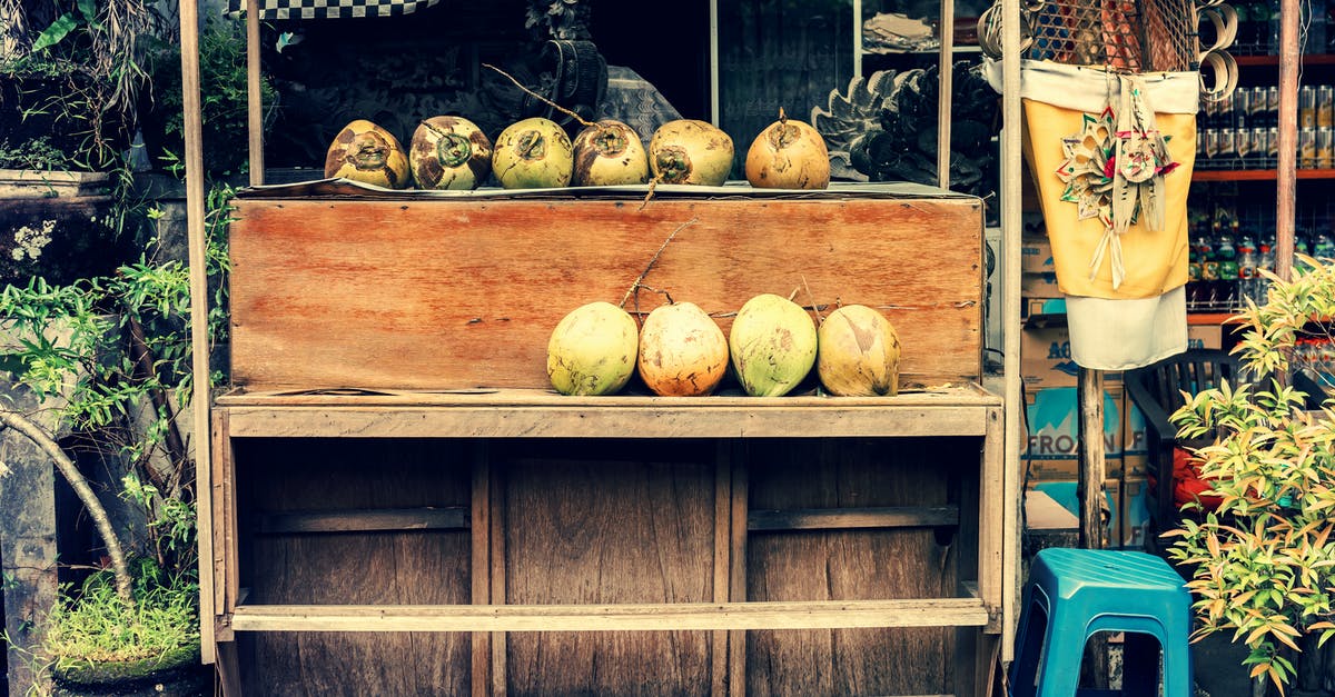 Storing/transporting nut brittle in tins - Photo of Store Selling Coconuts Storing/transporting nut brittle in tins - Photo of Store Selling Coconuts