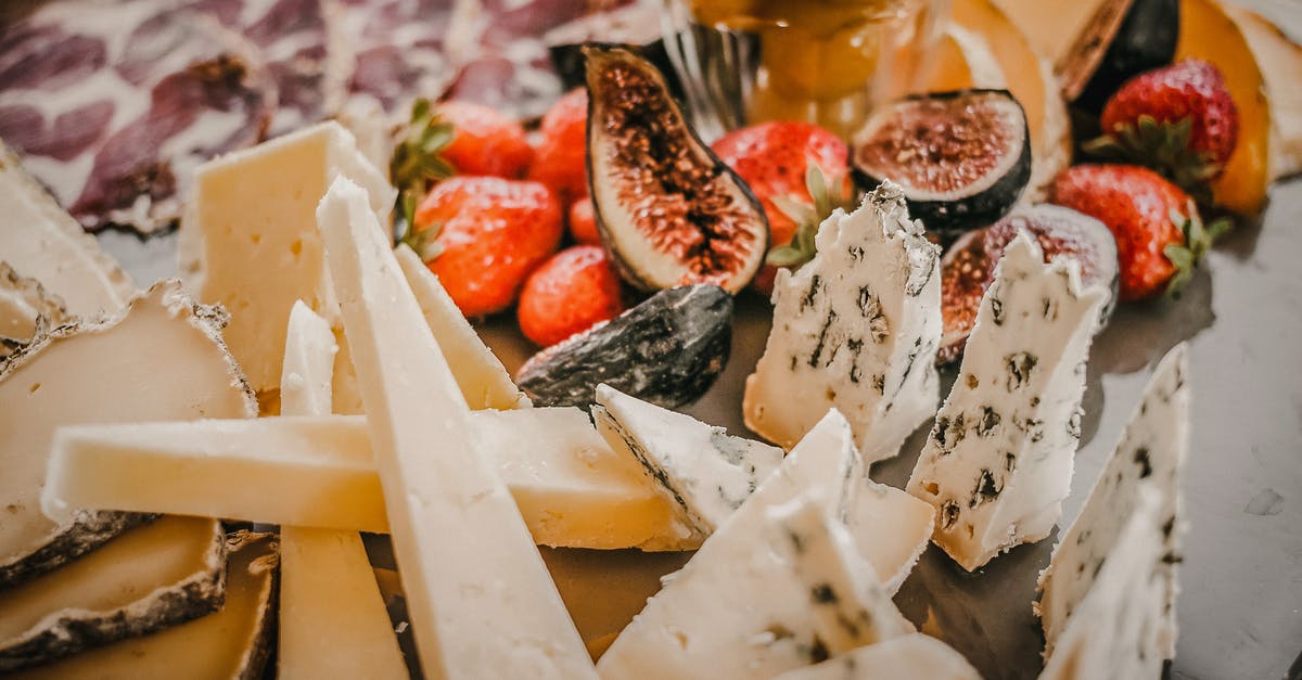 strawberry and fig vincotto - Various types of cheese near fruits and berries strawberry and fig vincotto - Various types of cheese near fruits and berries