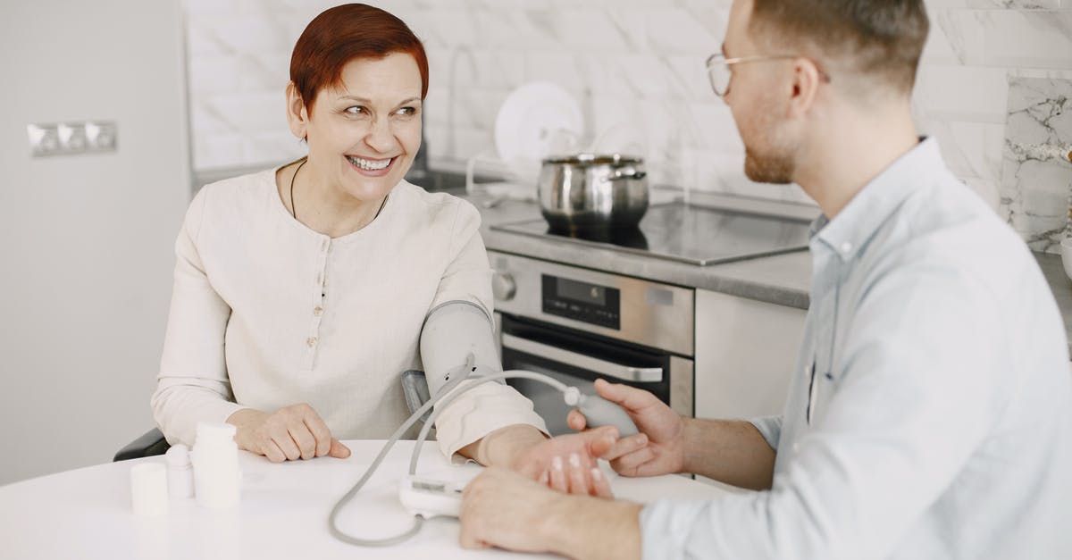 Substitute for blood? - A Man Sitting at a Table Checking a Woman's Blood Pressure Substitute for blood? - A Man Sitting at a Table Checking a Woman's Blood Pressure