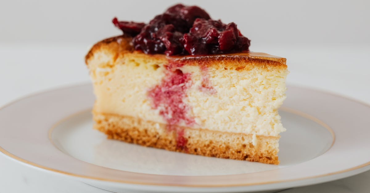 Substitute maple syrup with regular syrup for baking? [closed] - Closeup of piece of yummy homemade cheesecake with berries in syrup on top served on plate