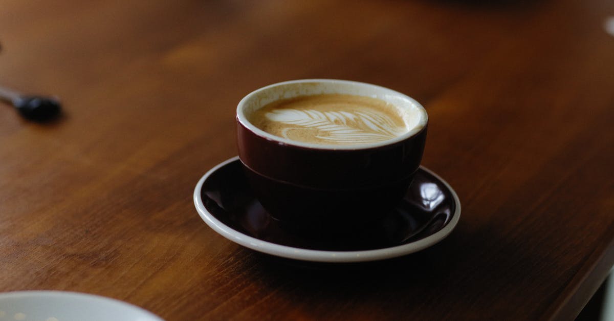Substituting almond milk for regular milk in coffee without bitterness - Cup of Coffee over a Wooden Table Substituting almond milk for regular milk in coffee without bitterness - Cup of Coffee over a Wooden Table