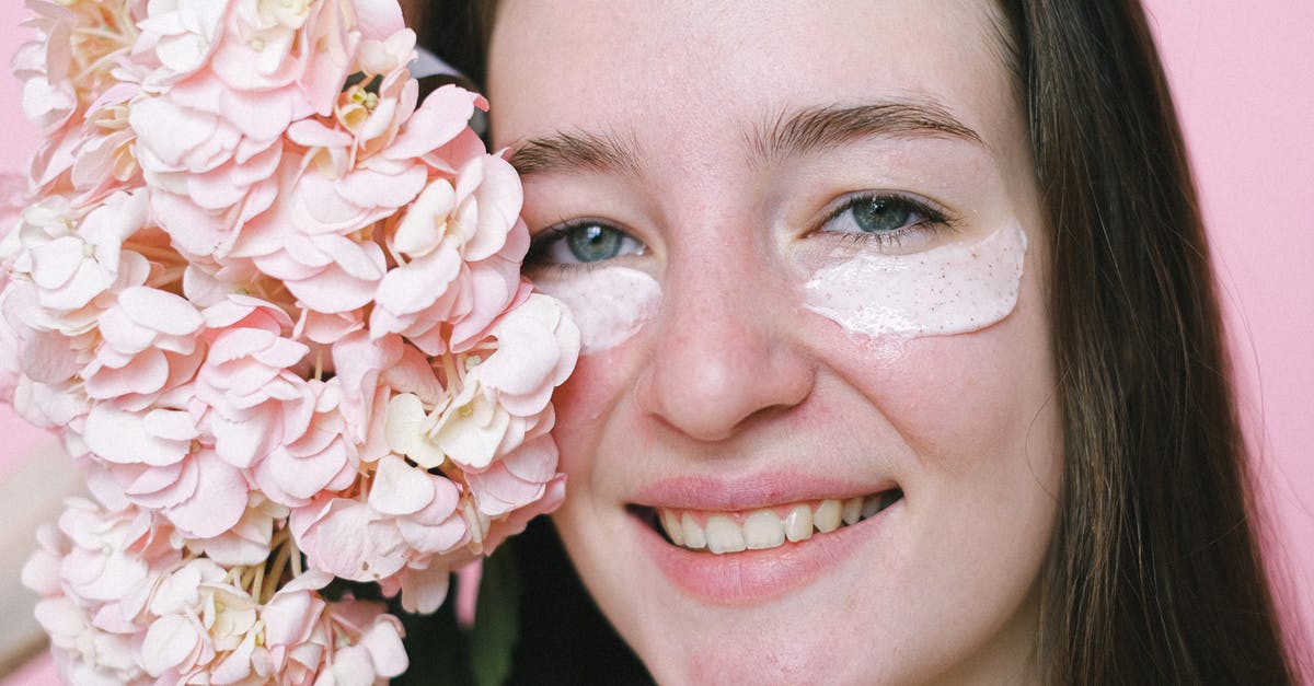 Substituting cream of tartar in turkish delights? - Crop positive young female model with eyes mask smiling at camera while demonstrating hydrangea flower on pink background Substituting cream of tartar in turkish delights? - Crop positive young female model with eyes mask smiling at camera while demonstrating hydrangea flower on pink background