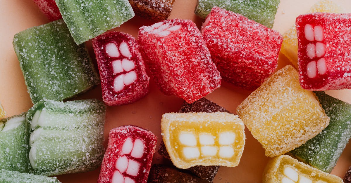 Sweet = Sugar, Salty = Salt, Sour =? - Set of colorful sour gummy sweets in sprinkle assorted chaotically on beige surface Sweet = Sugar, Salty = Salt, Sour =? - Set of colorful sour gummy sweets in sprinkle assorted chaotically on beige surface