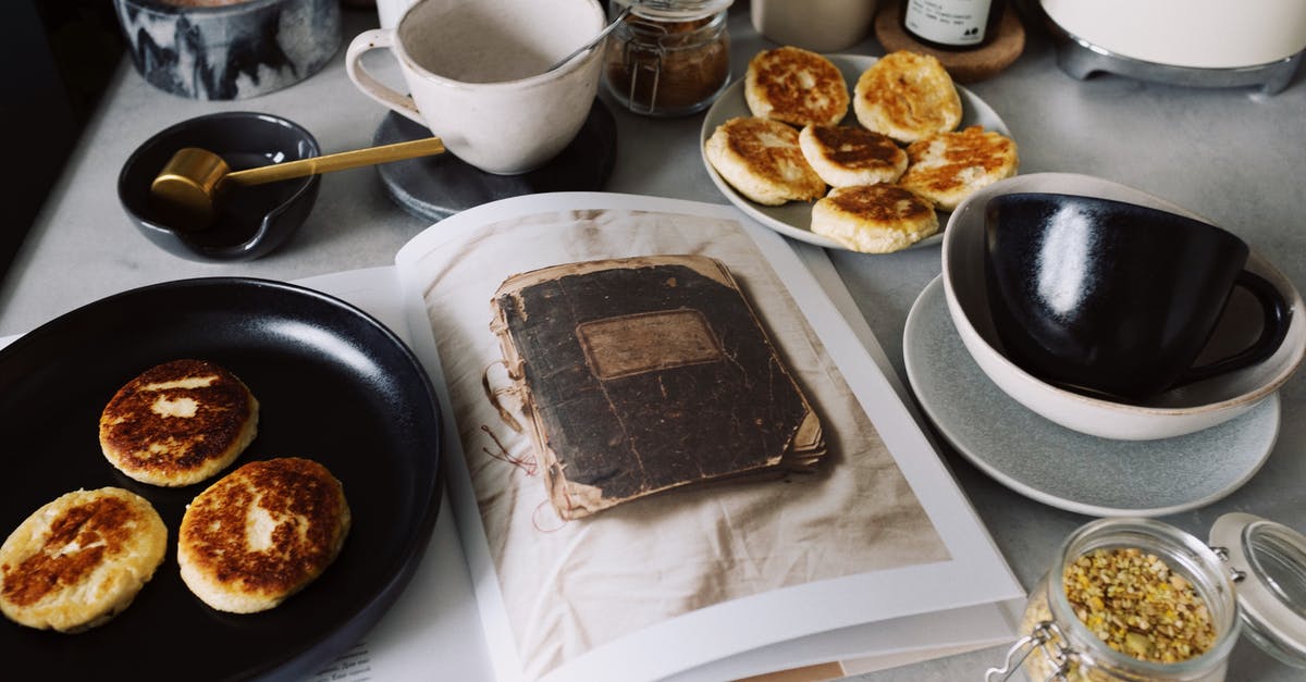 Sweet rice recipe help? Panama cook book recipe - From above view of black plate with fresh cheese pancakes on opened book placed on table with various kitchenware in modern apartment Sweet rice recipe help? Panama cook book recipe - From above view of black plate with fresh cheese pancakes on opened book placed on table with various kitchenware in modern apartment