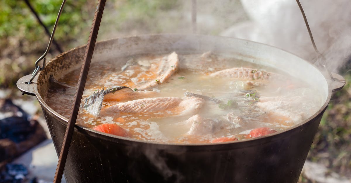 Szechuan fish soup ingredient -- what is it? - Tasty fish soup in cauldron with smoke outdoors Szechuan fish soup ingredient -- what is it? - Tasty fish soup in cauldron with smoke outdoors