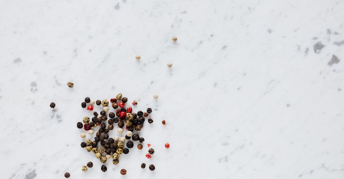 Taco Seasoning + Mustard smells like pickles - Top view of heap of assorted whole peppers on smooth marble light surface Taco Seasoning + Mustard smells like pickles - Top view of heap of assorted whole peppers on smooth marble light surface