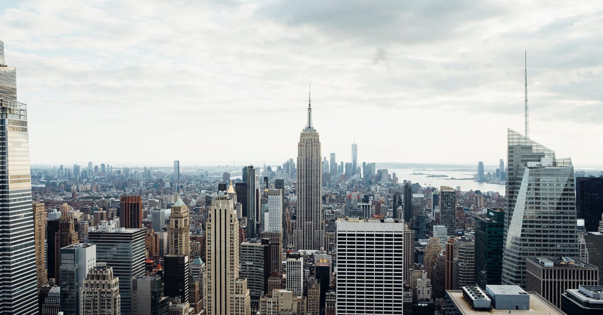 Tall cupcakes that have height to them - Drone view of empire state building located amidst high rise buildings on Manhattan in New York city against cloudy sky Tall cupcakes that have height to them - Drone view of empire state building located amidst high rise buildings on Manhattan in New York city against cloudy sky