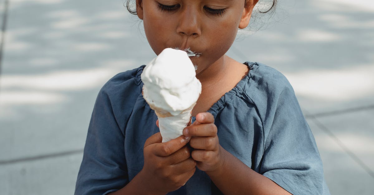Taste of pre-frozen lasagna - Asian girl eating ice cream on street Taste of pre-frozen lasagna - Asian girl eating ice cream on street