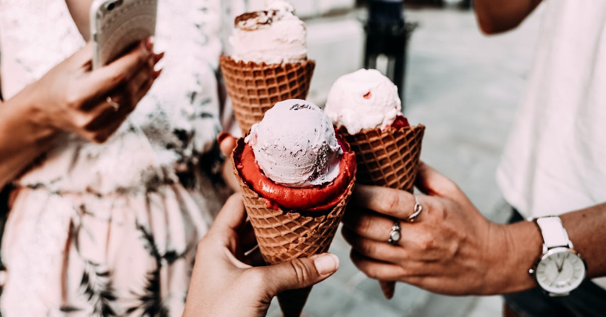 Taste of pre-frozen lasagna - Crop anonymous friends in casual summer clothes clinking delicious cone ice creams while gathering on street Taste of pre-frozen lasagna - Crop anonymous friends in casual summer clothes clinking delicious cone ice creams while gathering on street