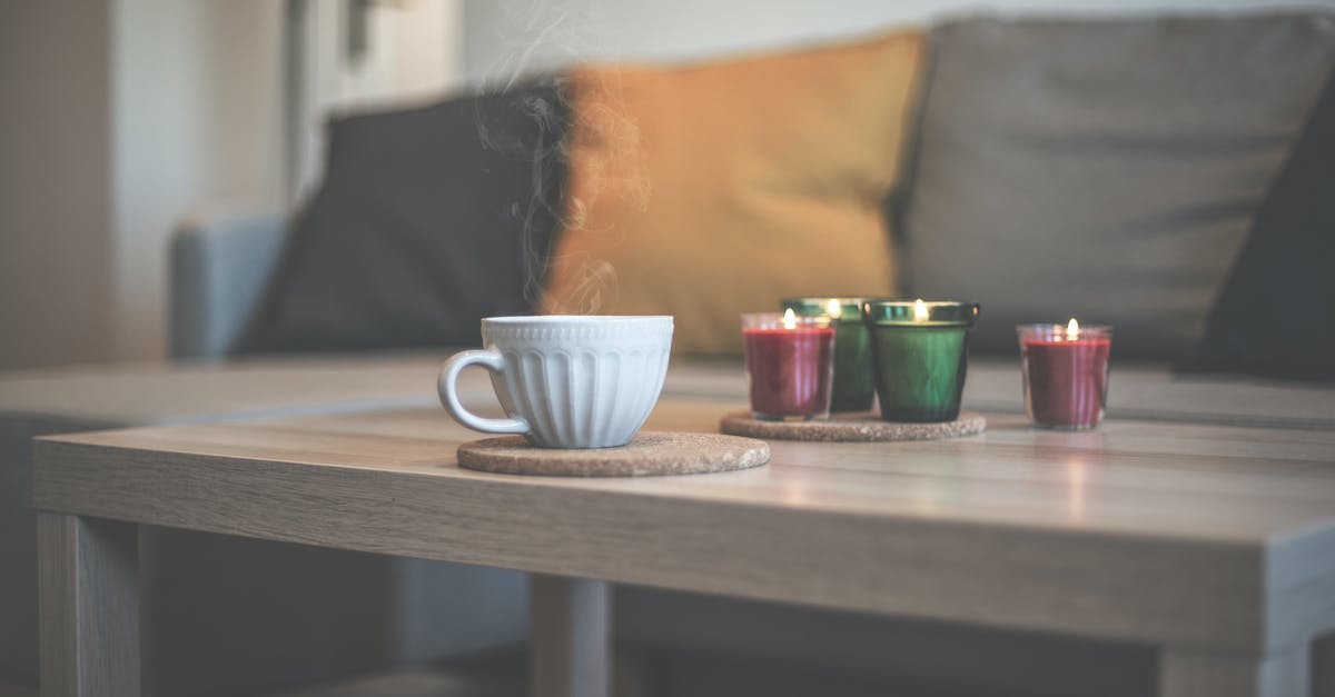 Tea cup residue - White Ceramic Teacup on Brown Wooden Table Tea cup residue - White Ceramic Teacup on Brown Wooden Table