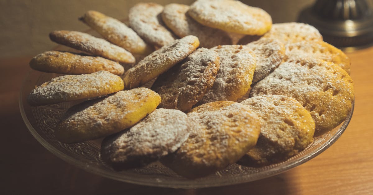 Texture issue in homemade powdered sugar - From above of delicious sweet baked cookies served on plate on wooden table Texture issue in homemade powdered sugar - From above of delicious sweet baked cookies served on plate on wooden table