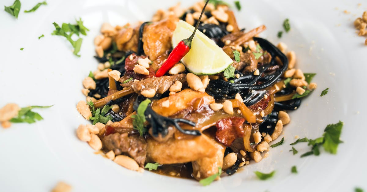 Thai noodle dish with peanuts - Delicious Asian pasta with meat slices and peanuts Thai noodle dish with peanuts - Delicious Asian pasta with meat slices and peanuts