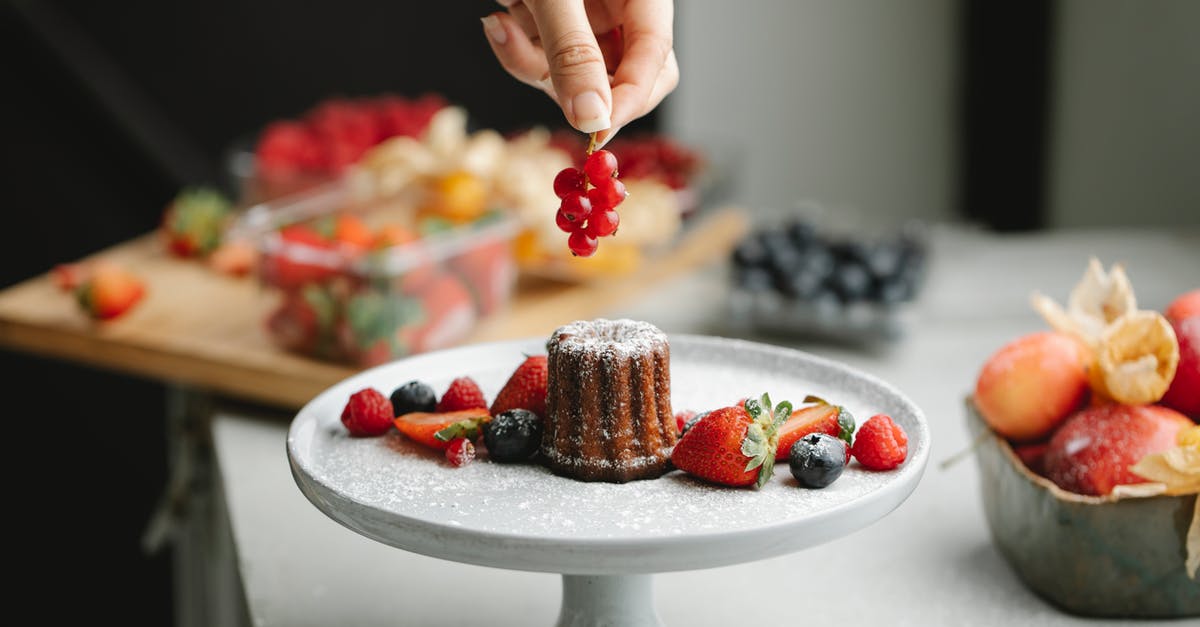Thawed frozen blueberries inside cake roll? - Crop woman putting berry on pie Thawed frozen blueberries inside cake roll? - Crop woman putting berry on pie
