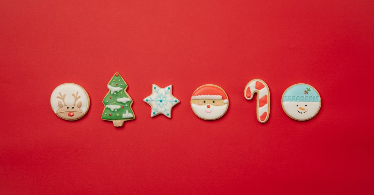 The difference between beet sugar and cane sugar - Top view of assorted Christmas cookies of different shapes decorated with colorful icing and arranged in row on red background The difference between beet sugar and cane sugar - Top view of assorted Christmas cookies of different shapes decorated with colorful icing and arranged in row on red background