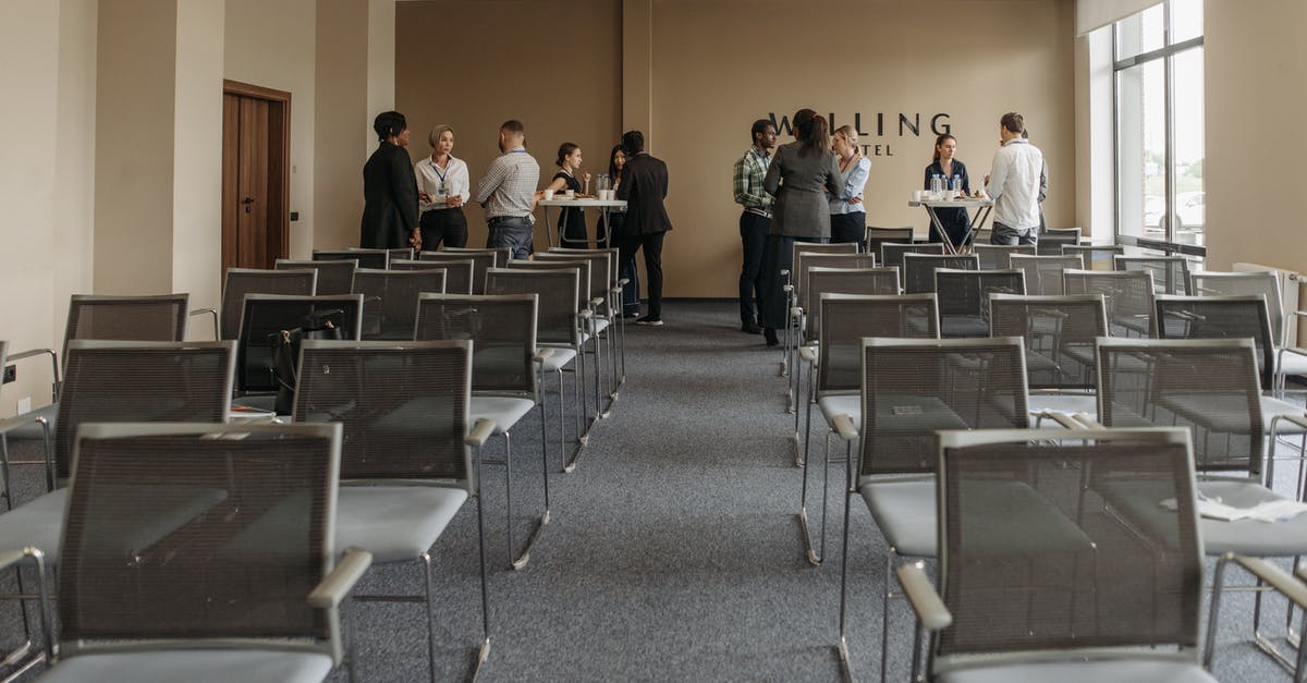 The function of glycerine in fondant - Group of People Standing and Talking in a Room