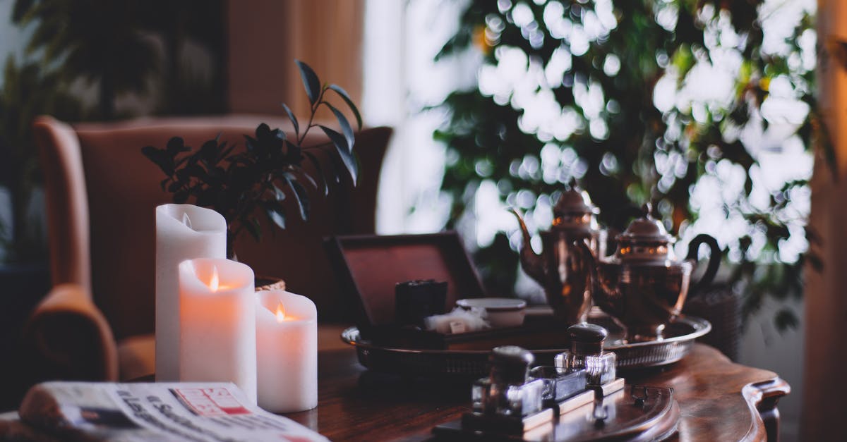 The side of my microwave set on fire - Flaming wax candles near metal teapots on tray and cozy armchair in house room The side of my microwave set on fire - Flaming wax candles near metal teapots on tray and cozy armchair in house room