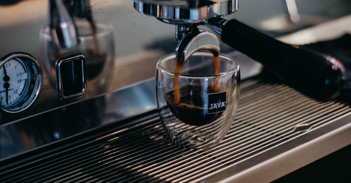 Tips for a small kitchen - Modern professional coffee machine pouring freshly brewed aromatic ristretto into small glass cup in coffee shop Tips for a small kitchen - Modern professional coffee machine pouring freshly brewed aromatic ristretto into small glass cup in coffee shop