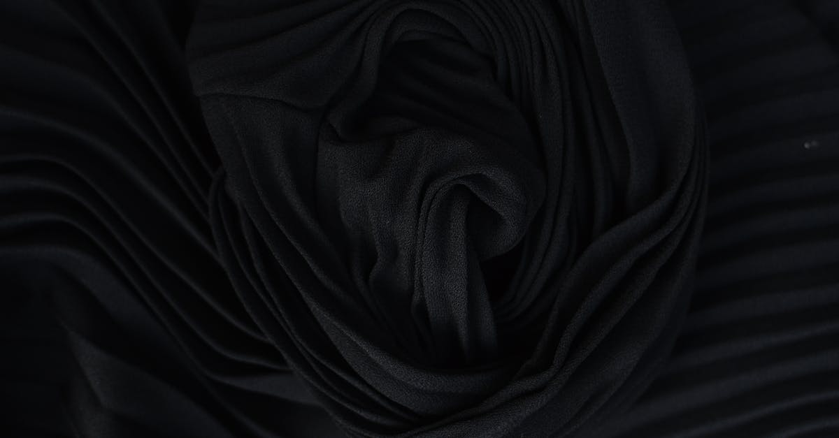 Tips for Removing Silk from Corn? - Top view of abstract background representing wavy creased black silk fabric in twilight Tips for Removing Silk from Corn? - Top view of abstract background representing wavy creased black silk fabric in twilight