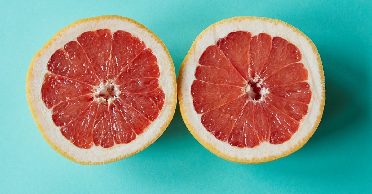 To chop or to blend? - Ripe sliced grapefruit placed on blue surface To chop or to blend? - Ripe sliced grapefruit placed on blue surface