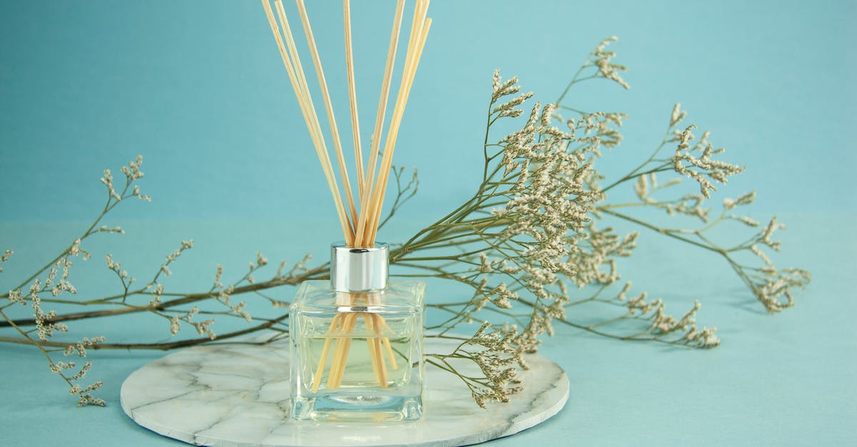 To finely spray a thin layer of warm liquid Coconut Oil? - Glass of natural essential oil with sticks To finely spray a thin layer of warm liquid Coconut Oil? - Glass of natural essential oil with sticks