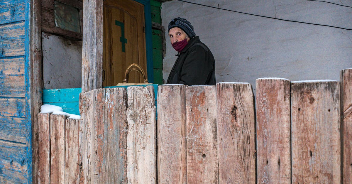 To lid or not to lid? - A Person Wearing Mask Near a Wooden Door To lid or not to lid? - A Person Wearing Mask Near a Wooden Door