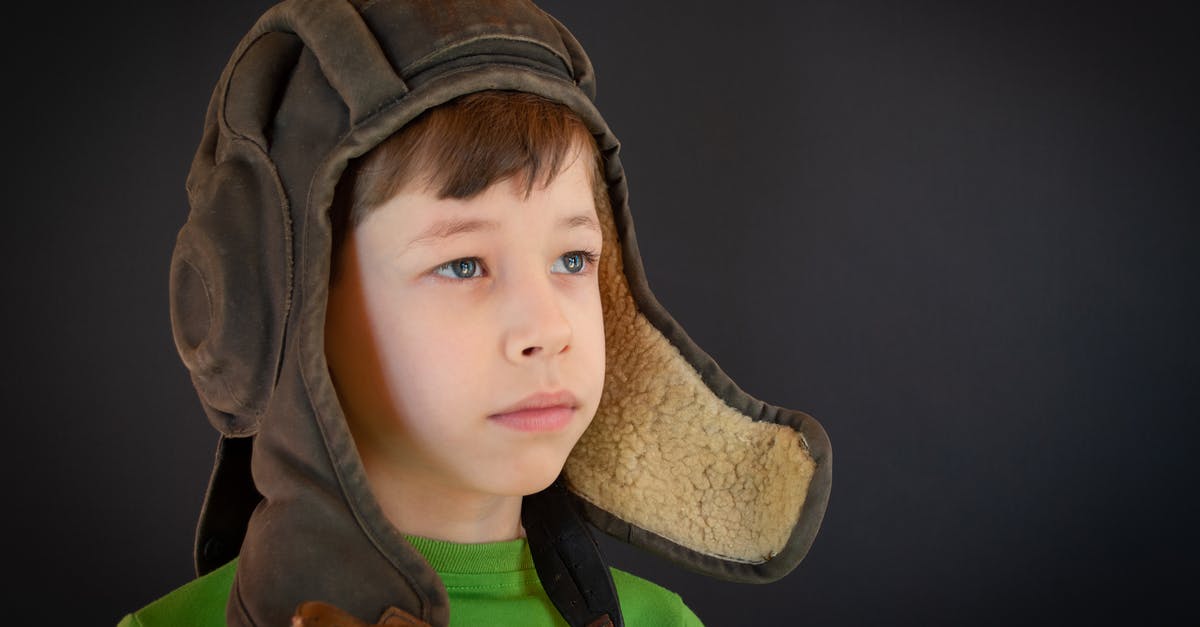 To lid or not to lid? - Boy in Green Hoodie With Brown Hat To lid or not to lid? - Boy in Green Hoodie With Brown Hat