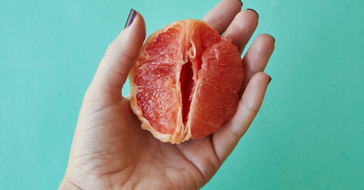 To what temperature should you take candied citrus peels? - From above of crop anonymous female demonstrating half of juicy peeled grapefruit as vagina against blue background in studio To what temperature should you take candied citrus peels? - From above of crop anonymous female demonstrating half of juicy peeled grapefruit as vagina against blue background in studio