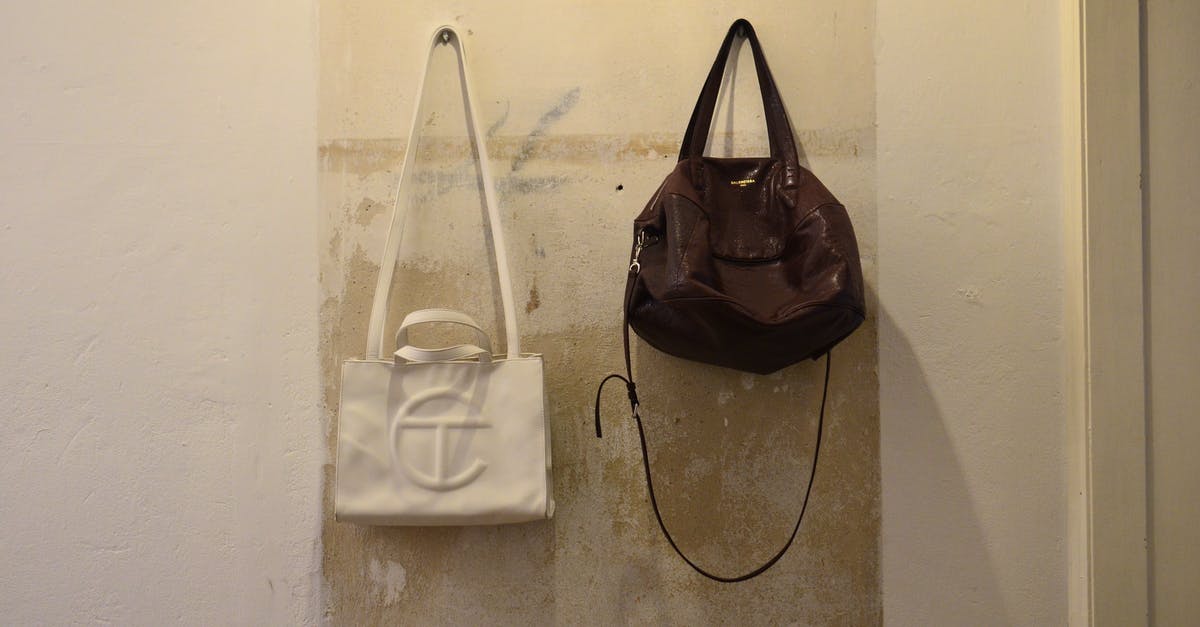 Toads with a flat batter-y - Bag hanging on shabby wall Toads with a flat batter-y - Bag hanging on shabby wall