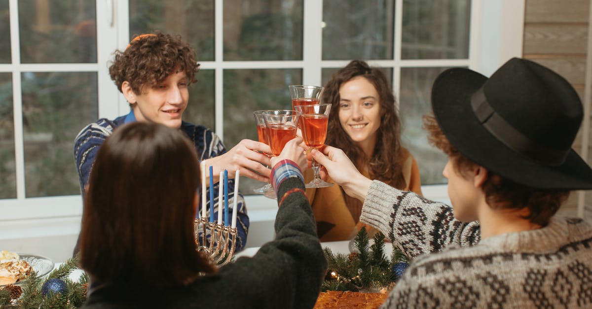 Toasting chopped almonds - Friends Sitting at the Dinner Table Toasting Their Glasses Toasting chopped almonds - Friends Sitting at the Dinner Table Toasting Their Glasses