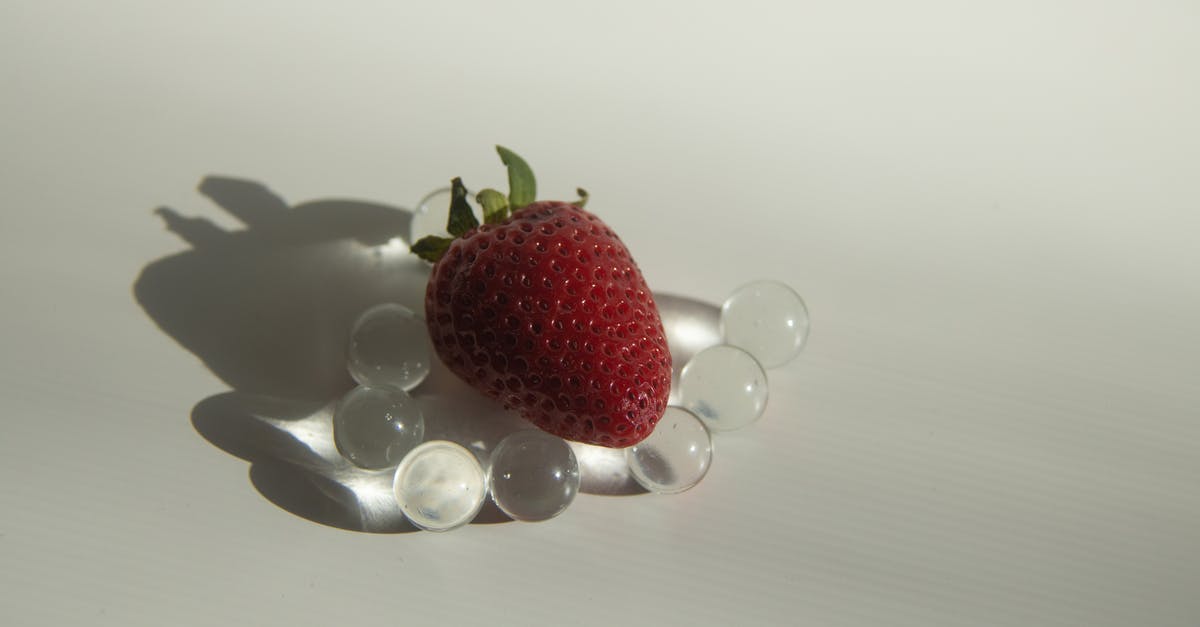 Tool for making small balls of sticky food - Sweet strawberry placed on small glass balls Tool for making small balls of sticky food - Sweet strawberry placed on small glass balls