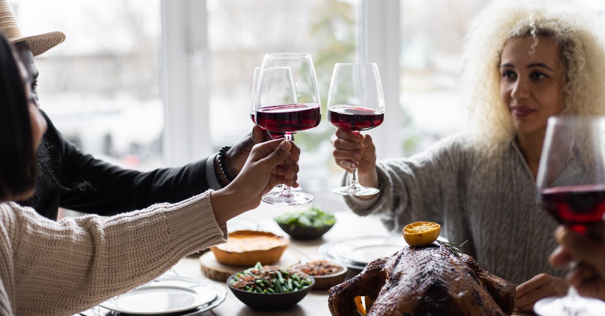 Turkey Dinners For A Group of 140 People - Multiethnic people clinking glasses having dinner Turkey Dinners For A Group of 140 People - Multiethnic people clinking glasses having dinner