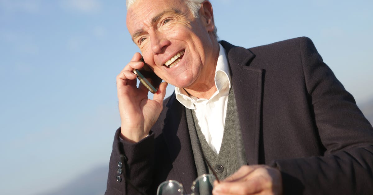 turkish delight is "grainy" - Mature businessman having conversation on smartphone in city turkish delight is "grainy" - Mature businessman having conversation on smartphone in city