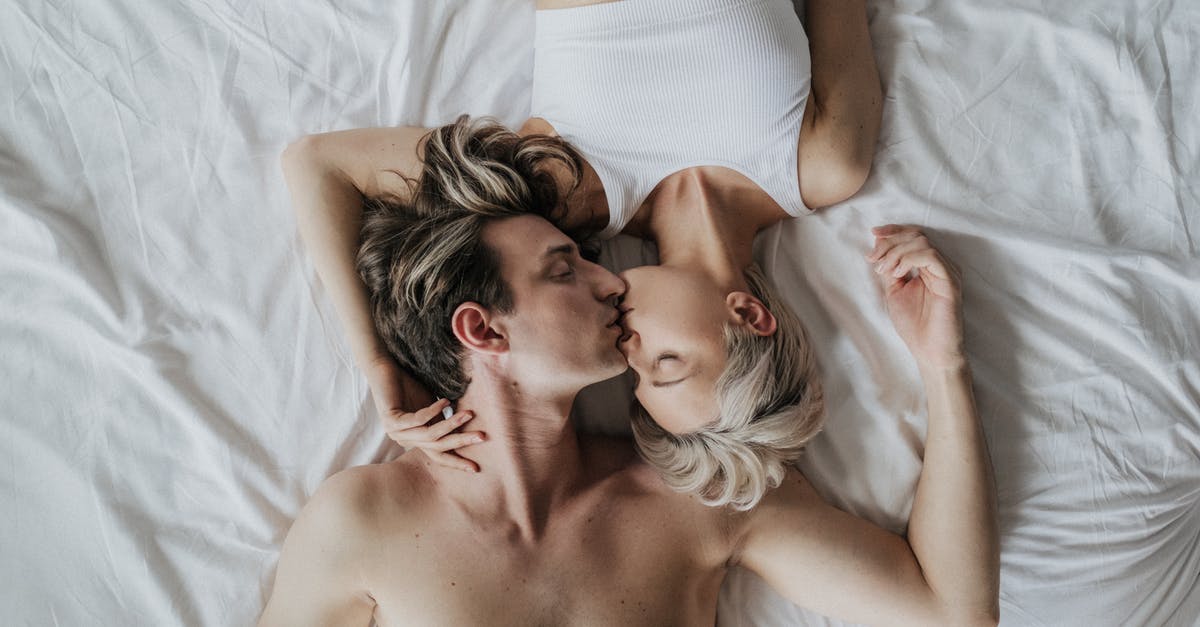 Turning focaccia upside down before topping - Woman and Man Kissing on Bed Turning focaccia upside down before topping - Woman and Man Kissing on Bed