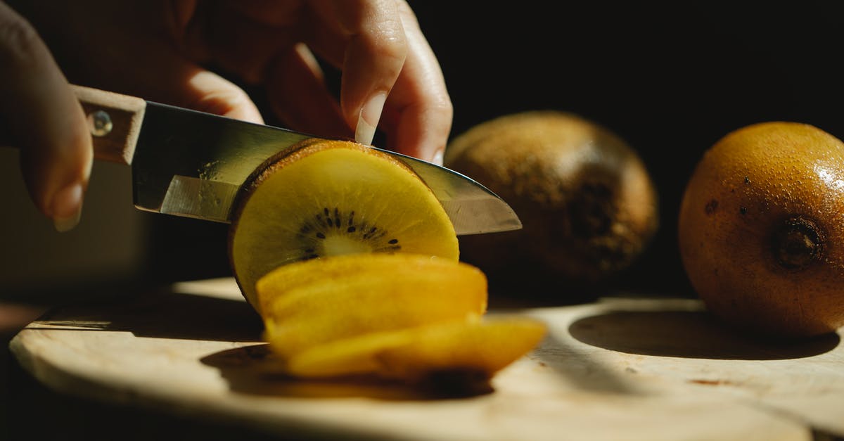 Under ideal circumstances, how easily should raw chicken cut when using a sharp knife? - Closeup of crop unrecognizable female cutting fresh ripe kiwi with small sharp knife on wooden chopping board Under ideal circumstances, how easily should raw chicken cut when using a sharp knife? - Closeup of crop unrecognizable female cutting fresh ripe kiwi with small sharp knife on wooden chopping board