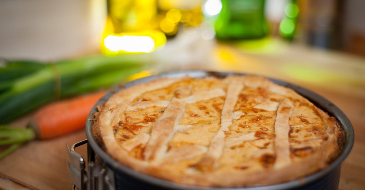 Undercooked Quiche - Black Round Container With Brown Food Near Carrot Undercooked Quiche - Black Round Container With Brown Food Near Carrot
