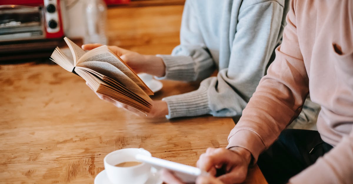 Unnecessary kitchen gadgets: a reference [closed] - From above of crop faceless spouses in casual clothes using tablet and reading book while sitting at wooden table with cups of cappuccino at home