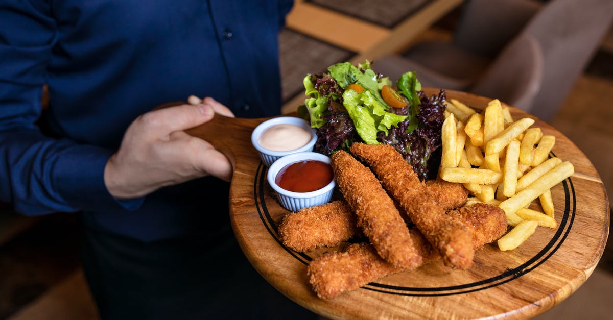 Unsure why foam sauce doesn't hold - Hand Holding Round Wooden Chopping Board with Food