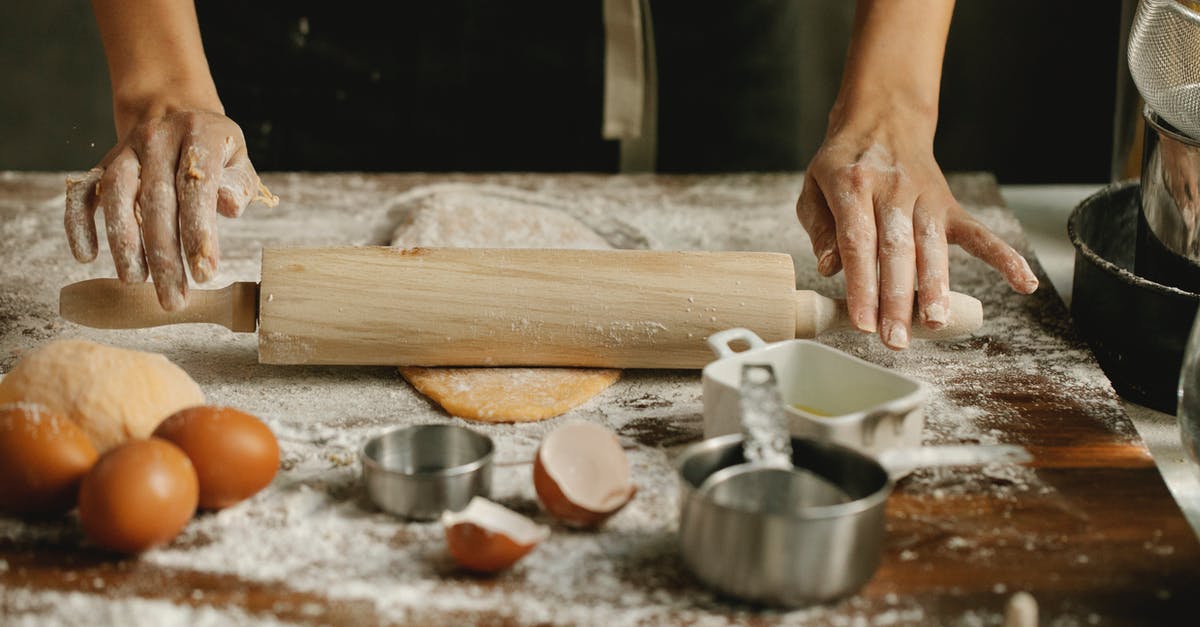 Use high gluten (bread) flour for hand pulled noodles - Chef rolling dough on table in kitchen Use high gluten (bread) flour for hand pulled noodles - Chef rolling dough on table in kitchen