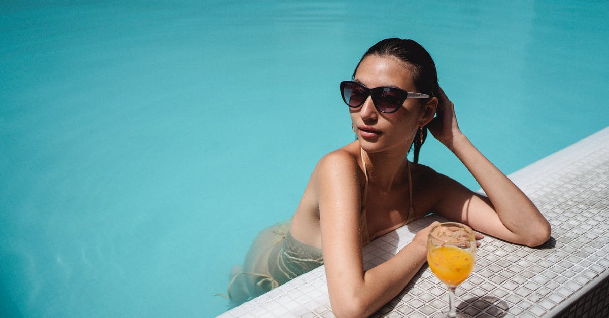 Use orange juice instead of water for syrup to make Orangettes? - Confident young Asian woman enjoying sunny day in pool with glass of juice Use orange juice instead of water for syrup to make Orangettes? - Confident young Asian woman enjoying sunny day in pool with glass of juice