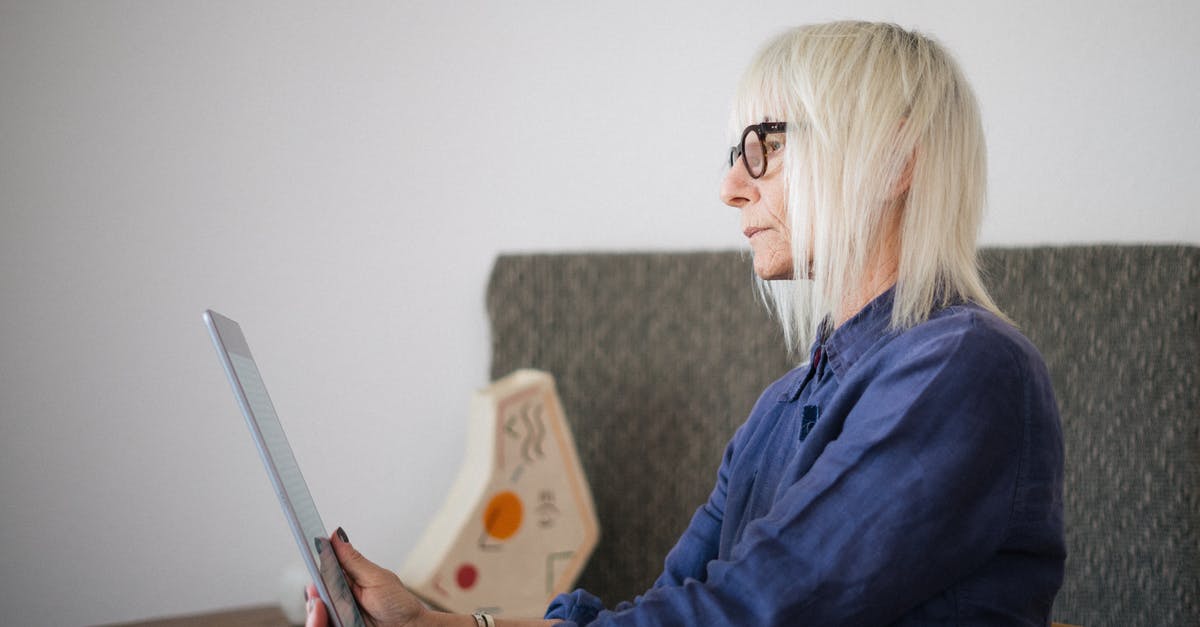 Used Pan.... Old Oil.... Can this pose a risk before washing? - Side view of stylish concentrated aged woman in casual outfit sitting with tablet at table at home Used Pan.... Old Oil.... Can this pose a risk before washing? - Side view of stylish concentrated aged woman in casual outfit sitting with tablet at table at home