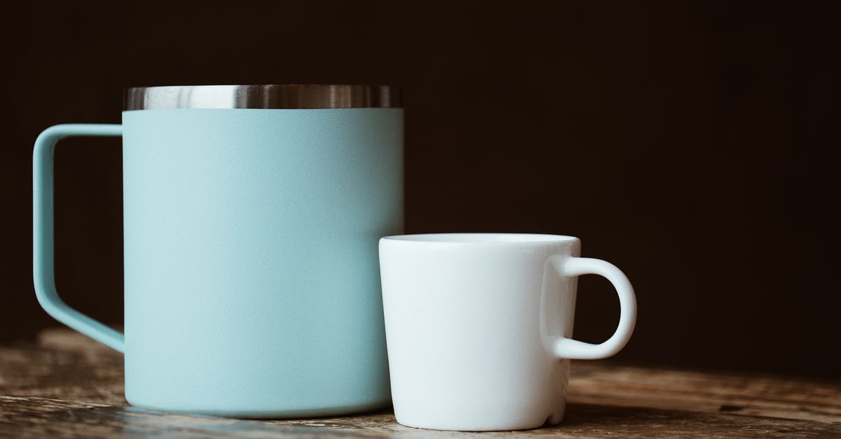 Used warm setting by accident [duplicate] - Blue and white mugs placed on shabby table