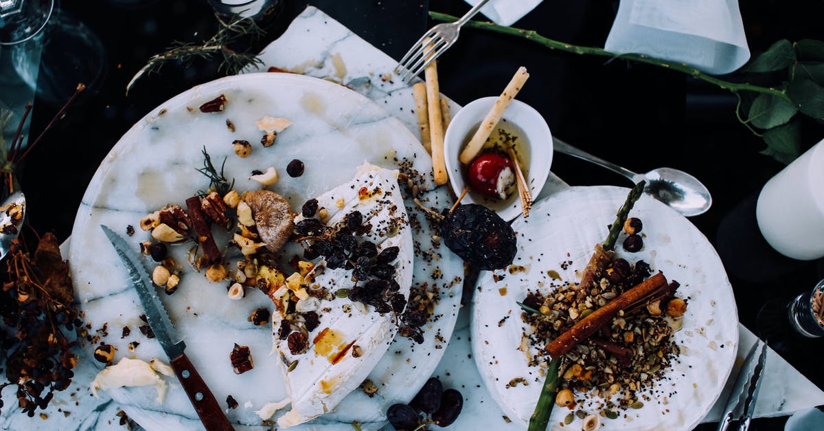 Uses for leftover potatoes from a pot-roast - From above of plates with remains of various dishes left after festive dinner on table with cutlery and flowers