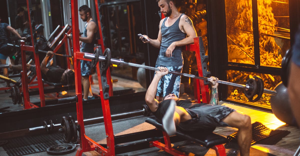 Using a Dutch Oven as a Heavy Skillet replacement - Sporty fitness trainer and man lifting barbell