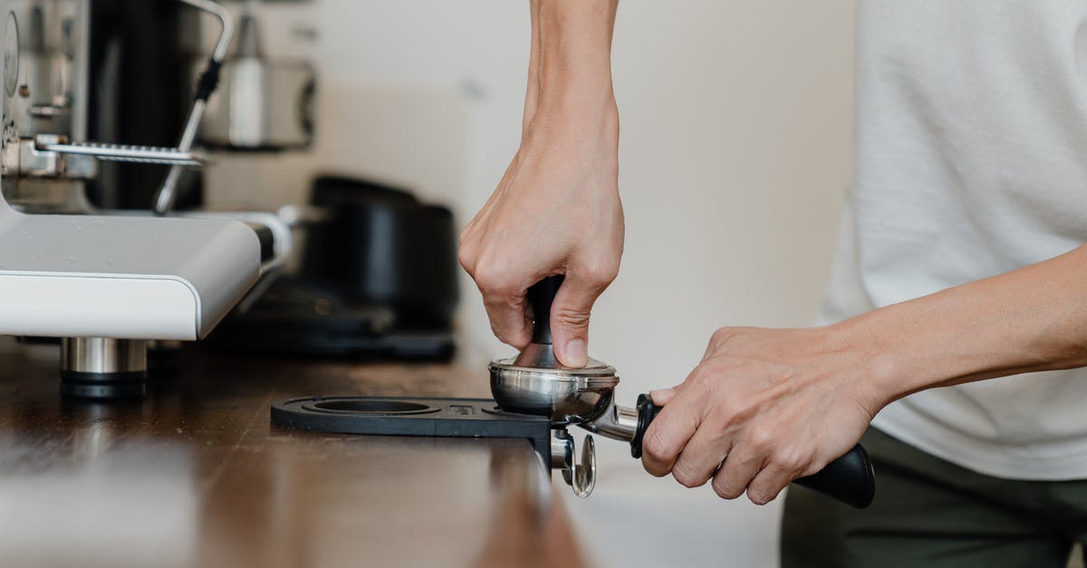 Using a French press with finely ground coffee - Crop professional barista preparing coffee at wooden counter Using a French press with finely ground coffee - Crop professional barista preparing coffee at wooden counter
