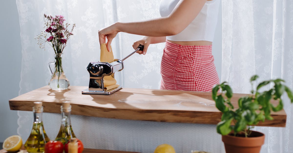 Using Elderberries in Cooking - Woman Using Pasta Maker Using Elderberries in Cooking - Woman Using Pasta Maker