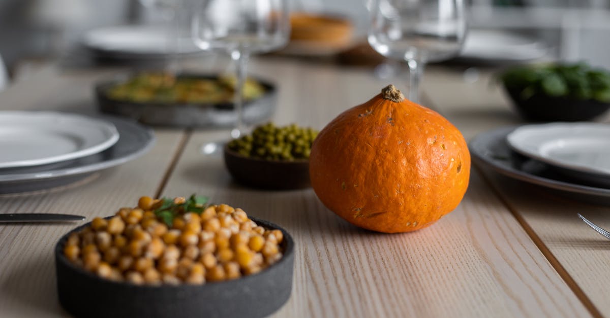 Using garbanzo flour instead of canned garbanzo beans - High angle of wooden table served with delicious chickpeas and fresh ripe pumpkin near empty plates and glasses for guests Using garbanzo flour instead of canned garbanzo beans - High angle of wooden table served with delicious chickpeas and fresh ripe pumpkin near empty plates and glasses for guests