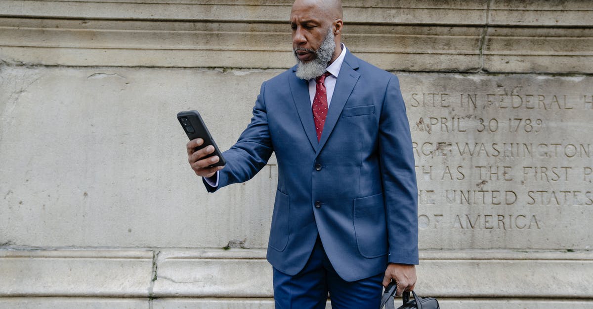 Using powdered salt vs regular - Man in Blue Suit Jacket Holding Black Smartphone Using powdered salt vs regular - Man in Blue Suit Jacket Holding Black Smartphone