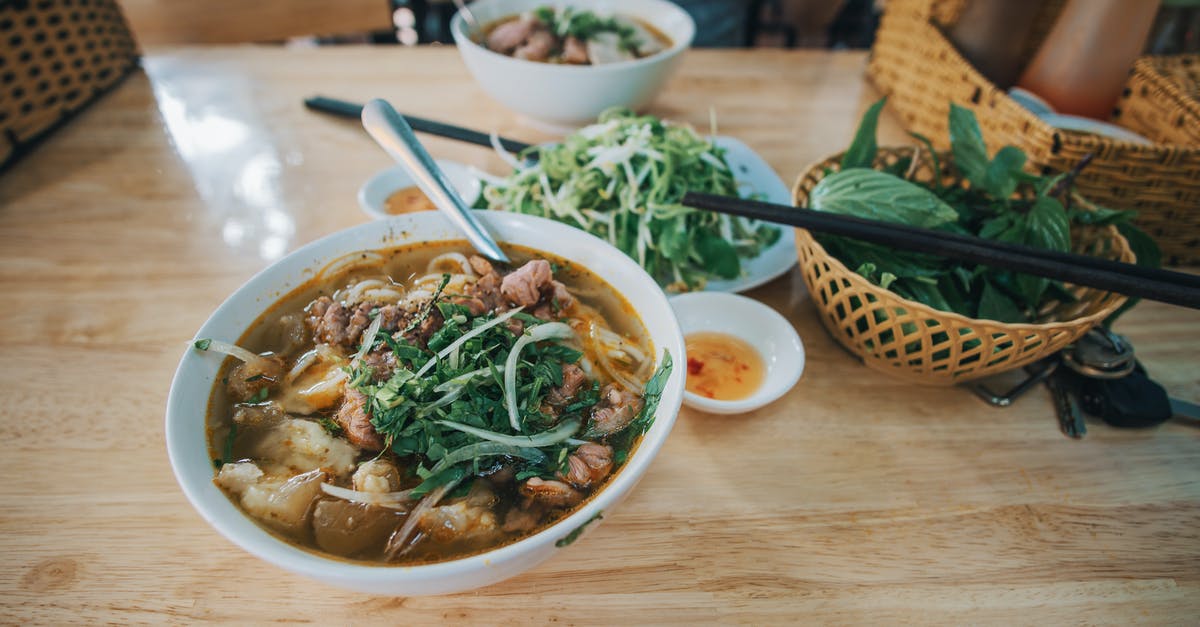 Using sauce as a soup base - Cooked Dish Beside Green Leafy Vegetables on Table Using sauce as a soup base - Cooked Dish Beside Green Leafy Vegetables on Table