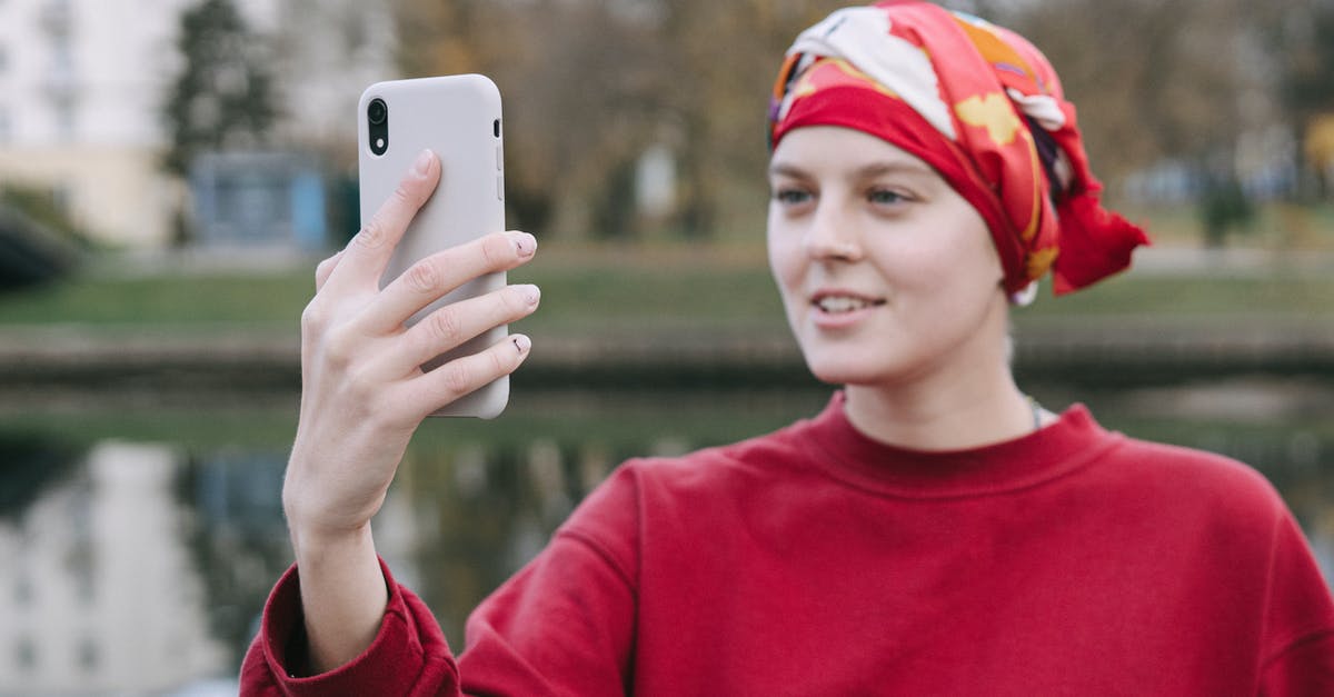 Using the right acid for red curry - A Woman Wearing Red Headscarf Using a Smartphone Using the right acid for red curry - A Woman Wearing Red Headscarf Using a Smartphone