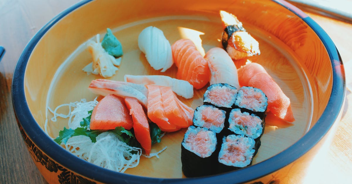 UV lamp to disinfect raw sushi fish slices - Delicious assorted sushi and rolls in bowl UV lamp to disinfect raw sushi fish slices - Delicious assorted sushi and rolls in bowl